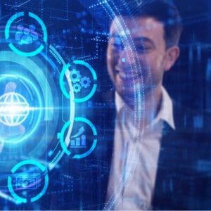 blue colours businessman smiling and looking at holographic interface with icons touching it with his finger