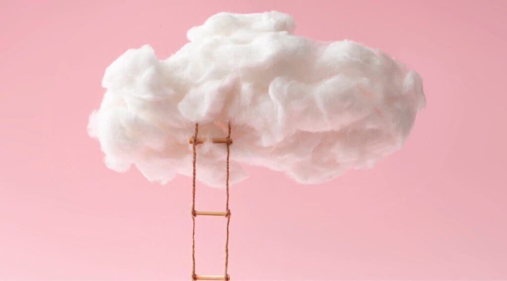 Pink background cotton wool as a cloud where a rope ladder with thin wooden steps leading into cloud